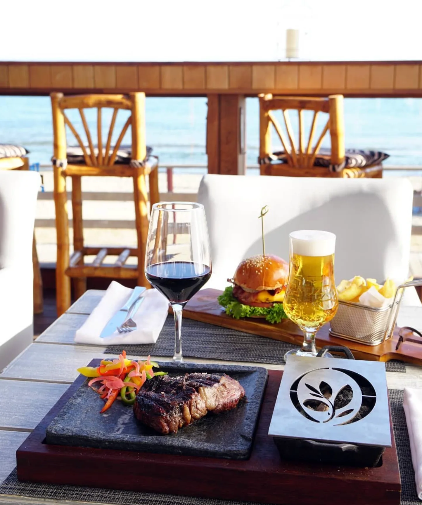 Luxury beachfront lunch at The Point Marbella with hot stone steak, red wine, craft beer and gourmet burger