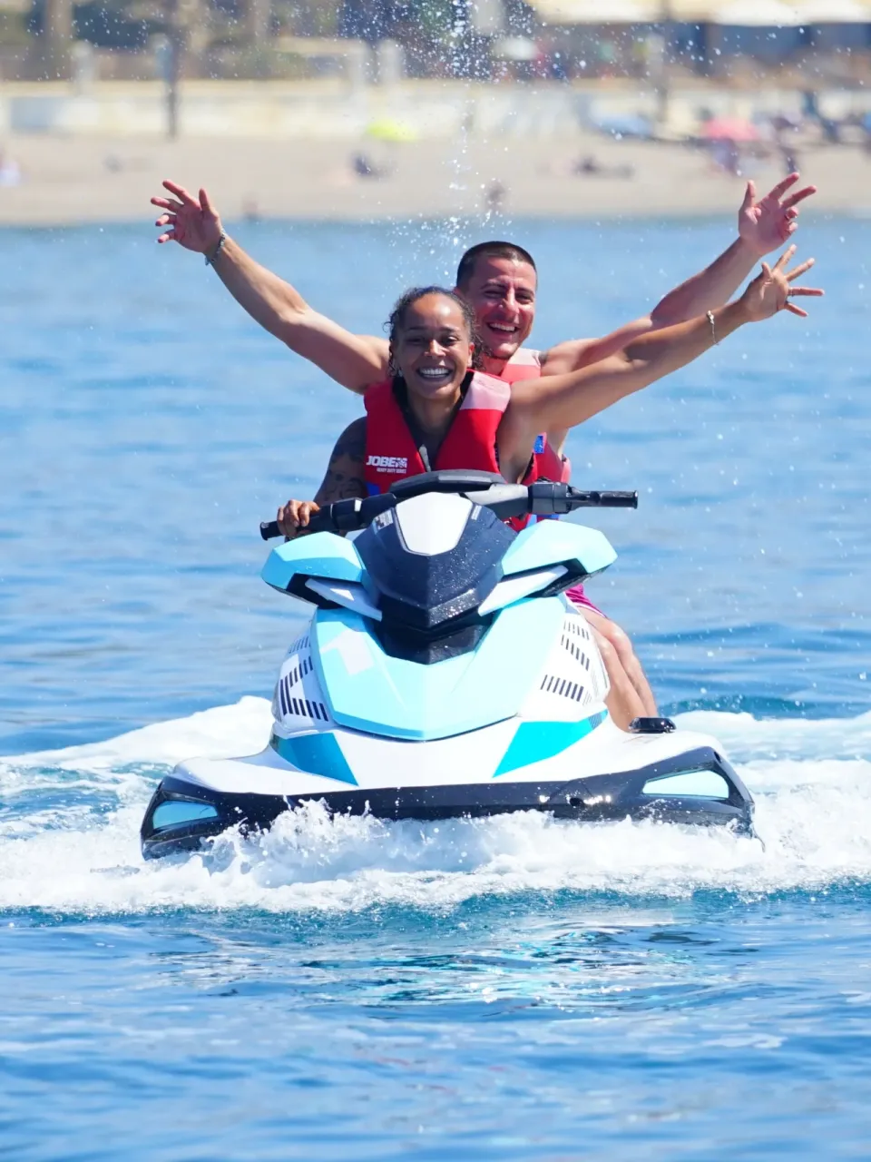 Couple on a jet ski off the beach in Marbella