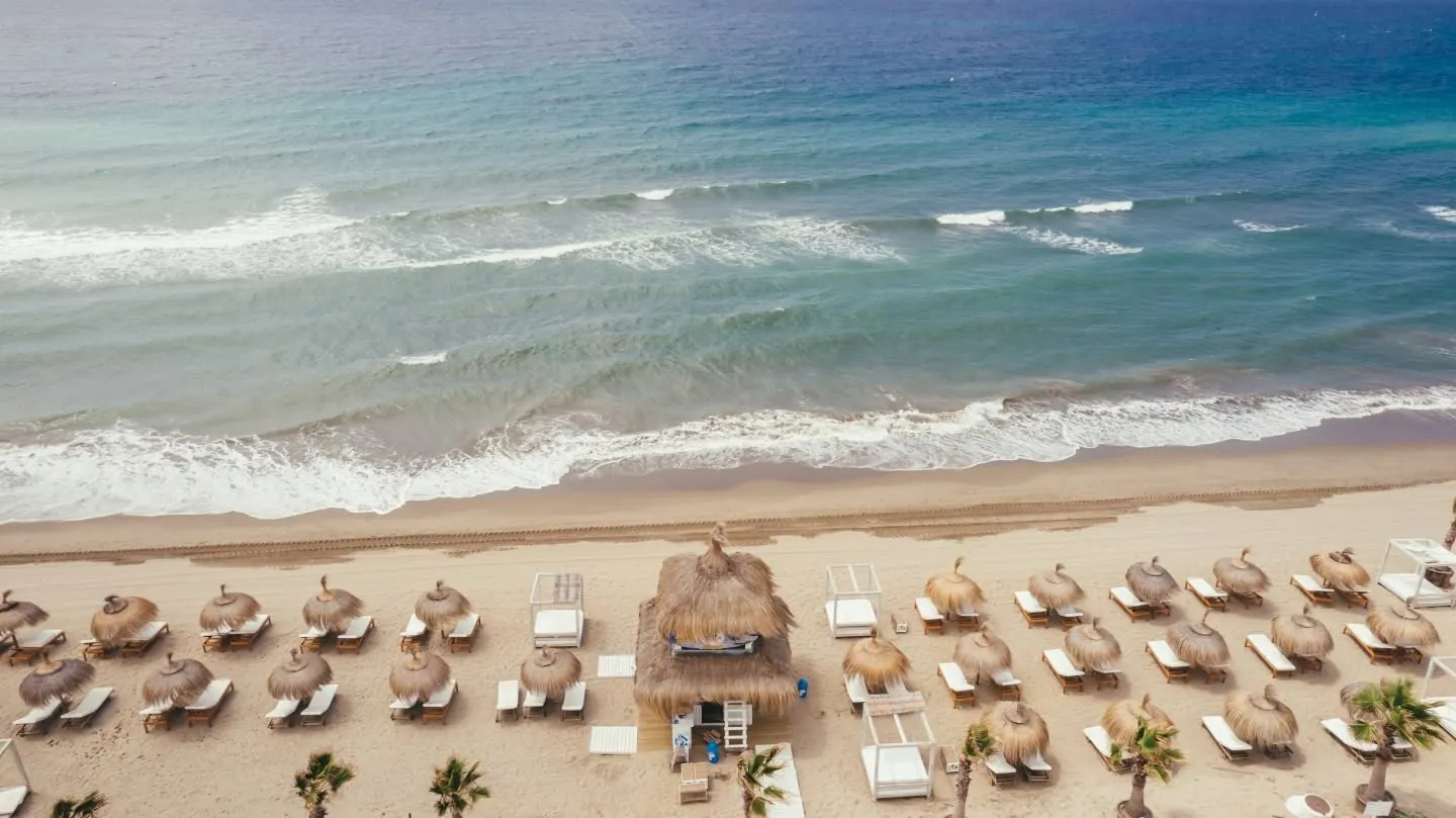 Aerial view of the beach and parasols at The Point Marbella