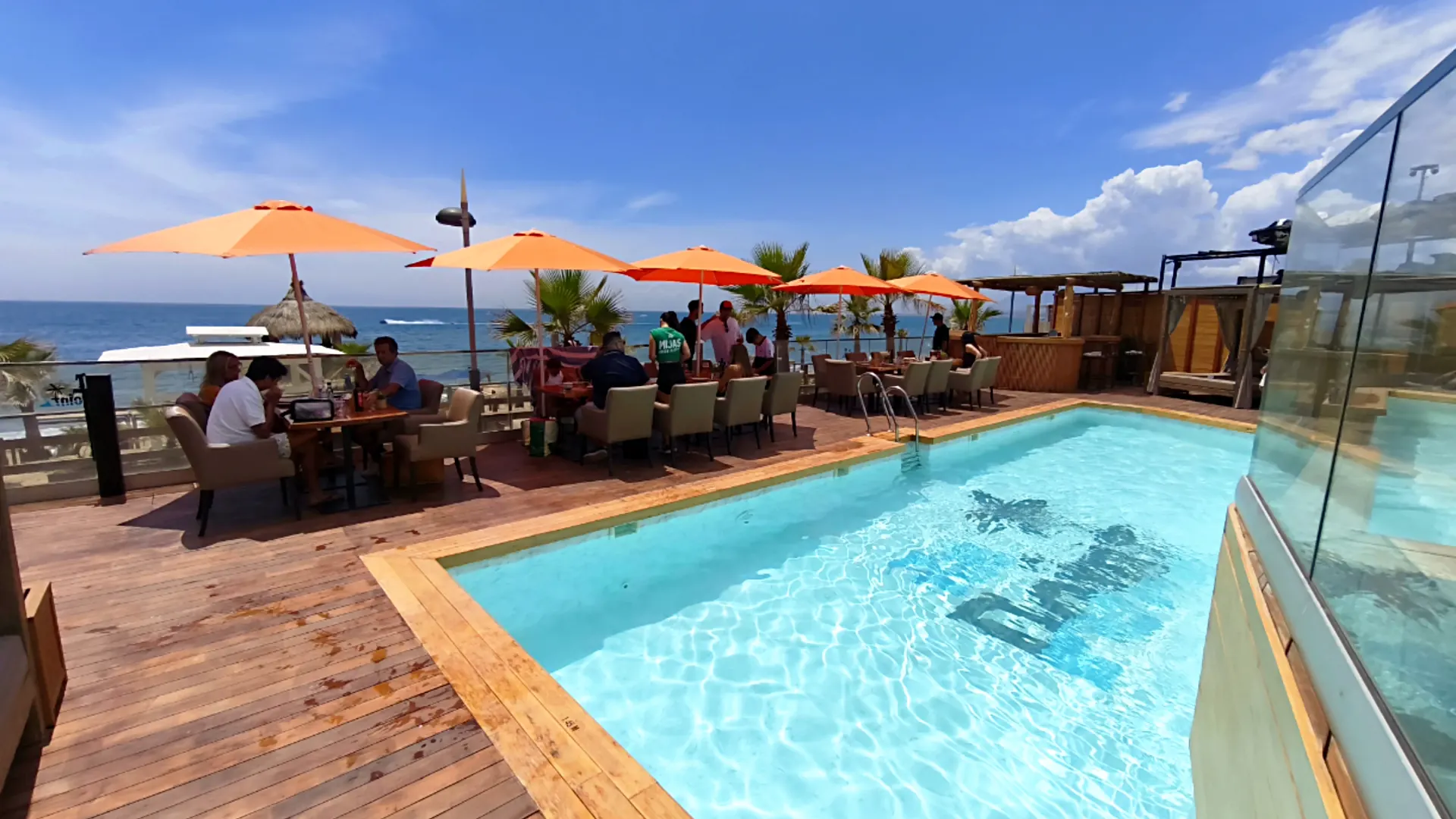 Pool and terrace with parasols at the beach club in Marbella