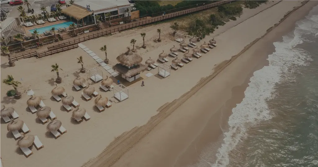 Aerial view of the beach and cabanas at The Point Marbella